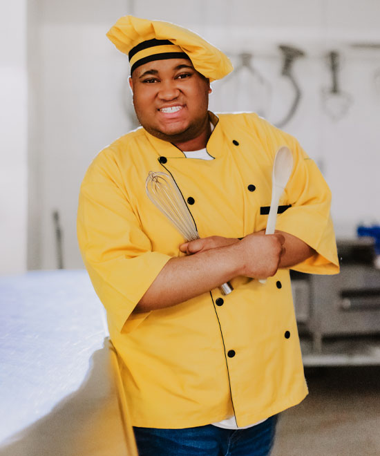 Shawn Rosier wearing a yellow chef jacket